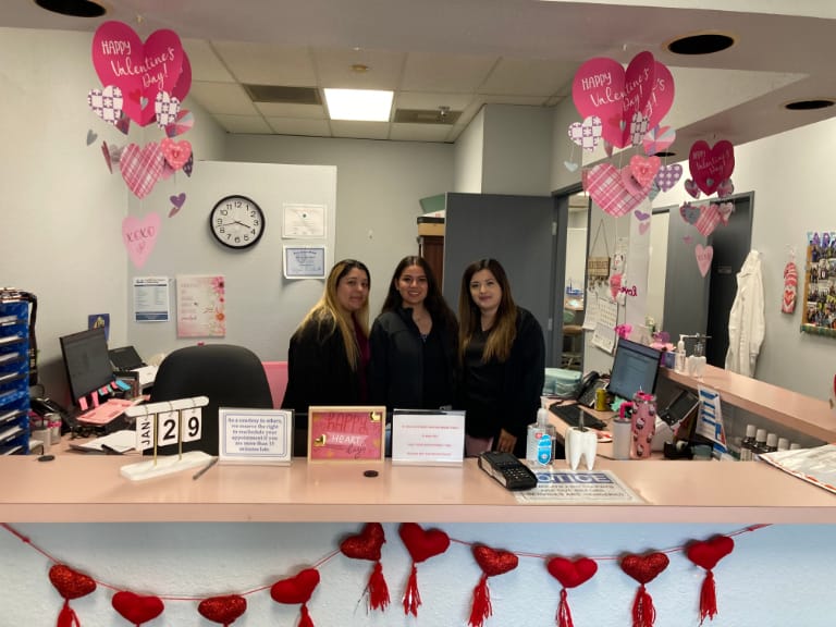 Front office staff standing behind the desk